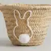 Het Paasmandje is een geweven mandje versierd met een wit konijntje en een pluizige witte pomponstaart aan de zijkant van het mandje.